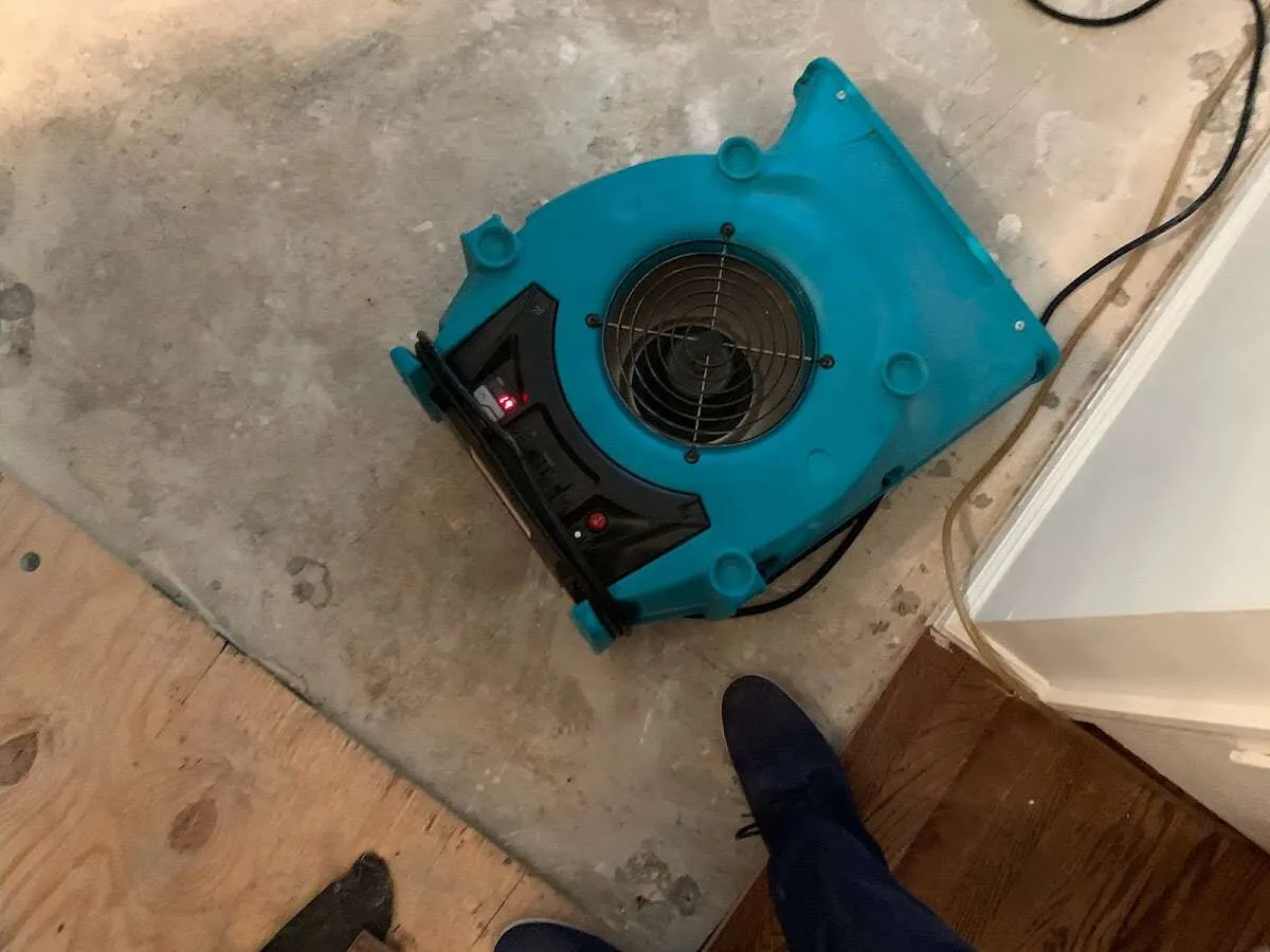 Air mover drying subfloor during Commercial Water Damage Restoration in Bigfork